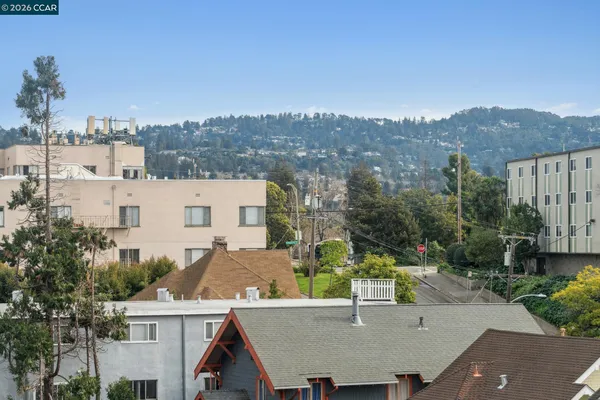 an aerial view of a house with a yard and mountain view