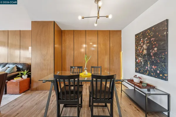 a view of a a dining room with furniture window and wooden floor