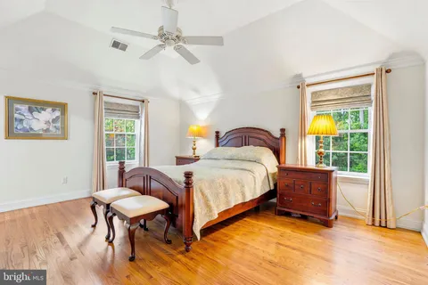 a living room with dining table a large window and kitchen view