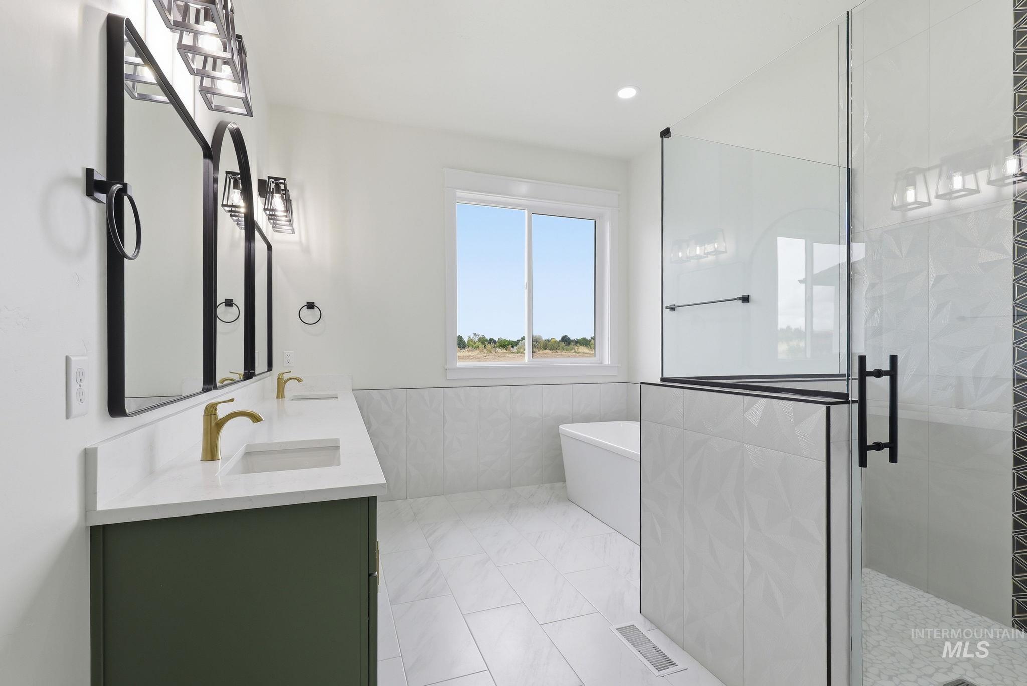 2321 Lower Bluff Road Emmett, ID 83617 - Photo 18 of 31 Room featuring dual windows with white trim, wood-finish flooring, white walls, and a contemporary ceiling fan with integrated lighting