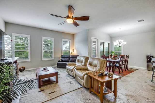 a living room with furniture and kitchen view