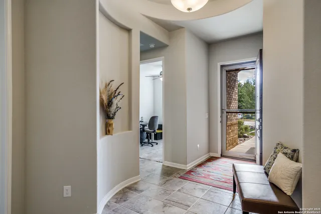 a view of a workspace with furniture and a window