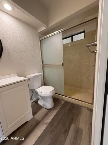 a bathroom with a toilet and a shower