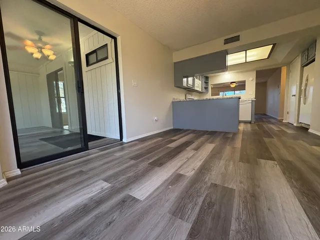 a view of a room with wooden floor