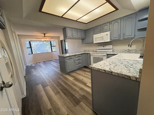 a kitchen with a sink stove and cabinets
