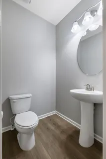 a bathroom with a sink toilet and a mirror