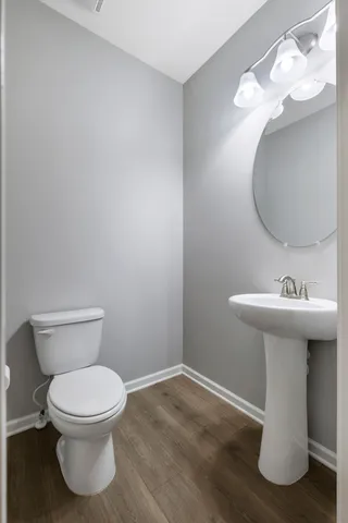 a bathroom with a sink toilet and a mirror
