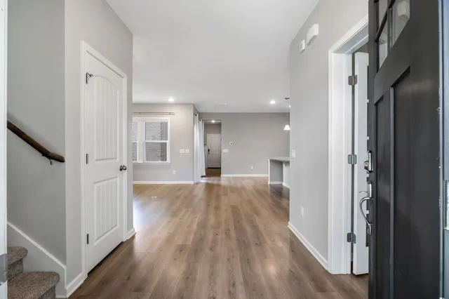 a view of empty room with wooden floor and window