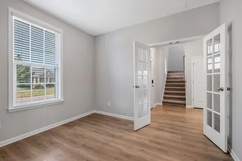 a view of wooden floor and windows in a room