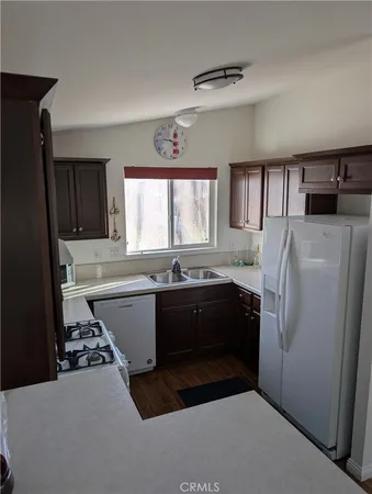 a kitchen with a refrigerator and a sink
