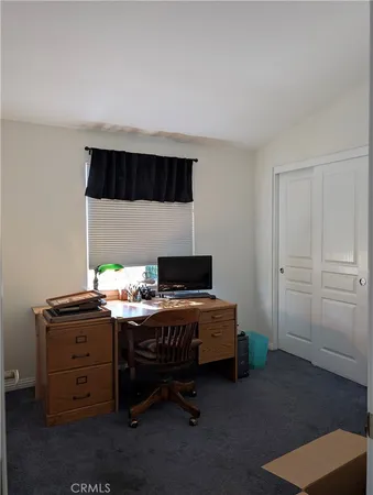 a bedroom with a bed and a desk