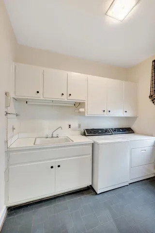 a spacious bathroom with a granite countertop sink a toilet and a mirror