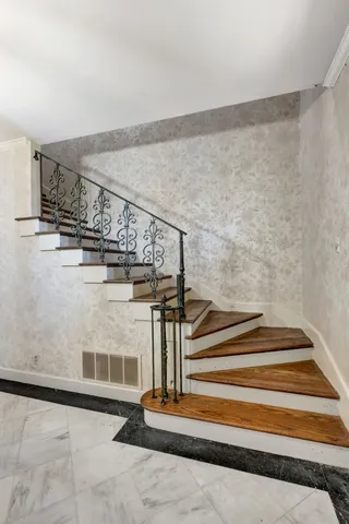 a view of an empty room with a chandelier fan