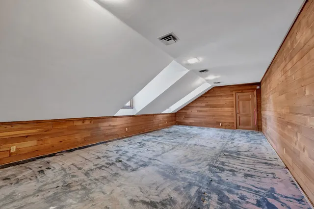 a view of a yard with plants and trees