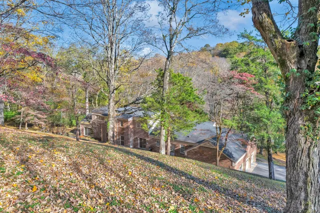a view of a yard with wooden fence