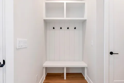 an empty room with wooden floor and window