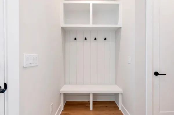 an empty room with wooden floor and window