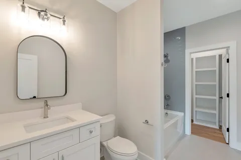 a kitchen with stove and wooden floor