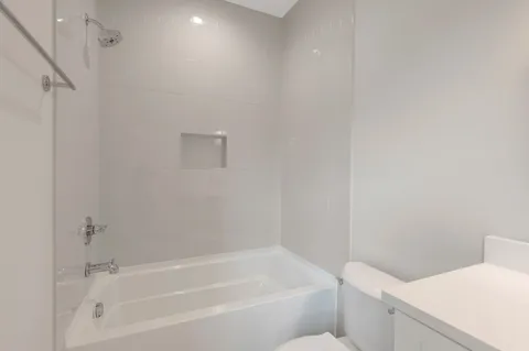 a view of an empty room with window and fire place