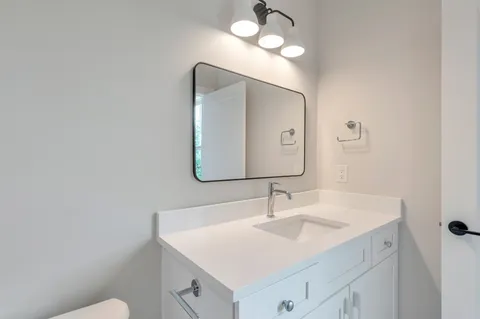 a view of a kitchen with a fireplace wooden floor and a chandelier
