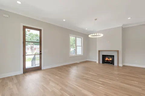 a kitchen with stainless steel appliances a white stove top oven and a wooden floor