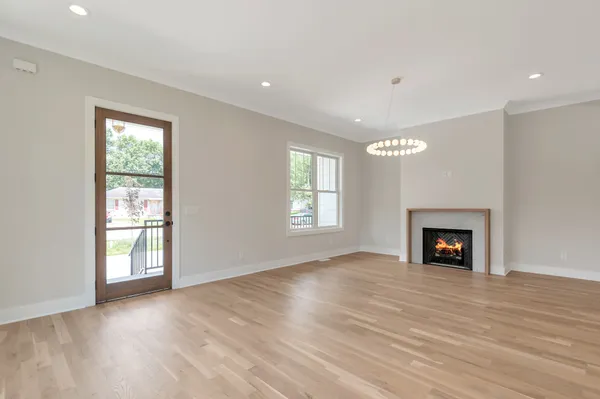 a kitchen with stainless steel appliances a white stove top oven and a wooden floor