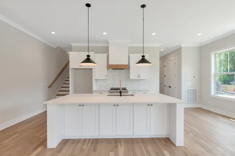 a stove top oven sitting inside of a kitchen