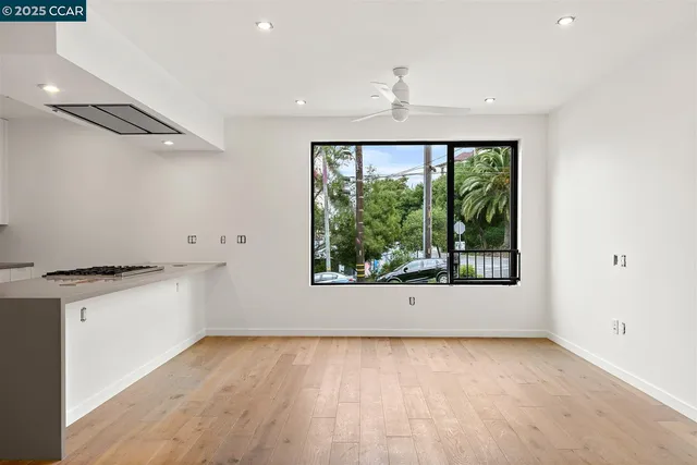 a view of a kitchen with a sink wooden floor and a window