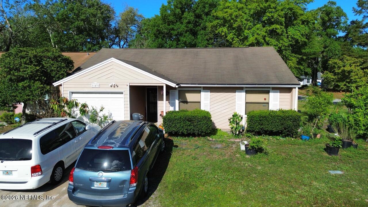 11432 Godfrey Way Jacksonville, FL 32223 - Photo 1 of 18 a front view of a house with garden
