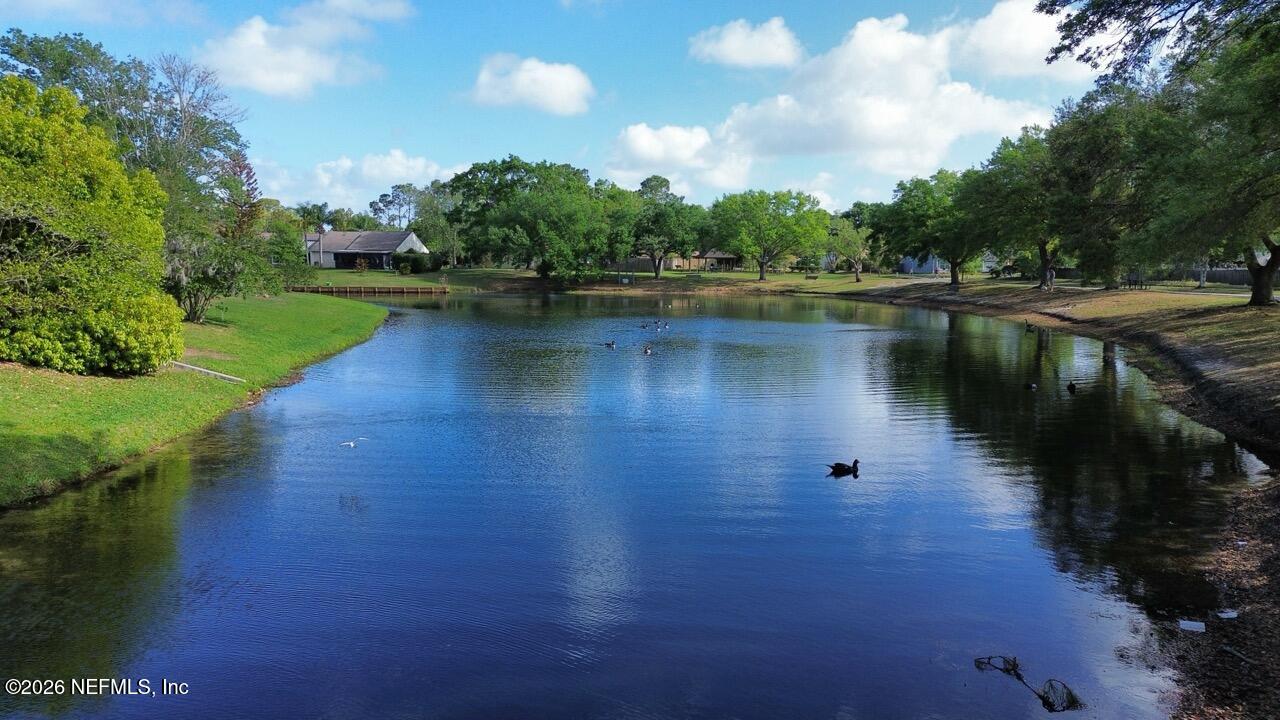 11432 Godfrey Way Jacksonville, FL 32223 - Photo 16 of 18 a view of a lake with a yard