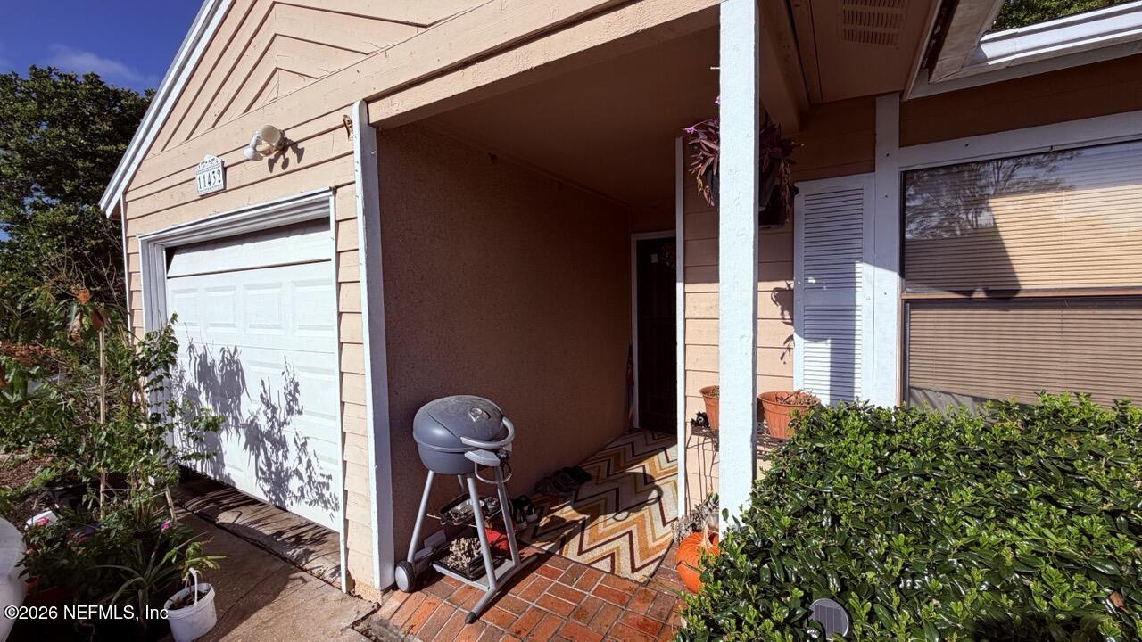 11432 Godfrey Way Jacksonville, FL 32223 - Photo 2 of 18 a backyard of a house with glass windows and furniture