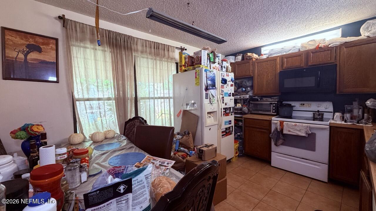 11432 Godfrey Way Jacksonville, FL 32223 - Photo 4 of 18 a living room with furniture a flat screen tv and a window