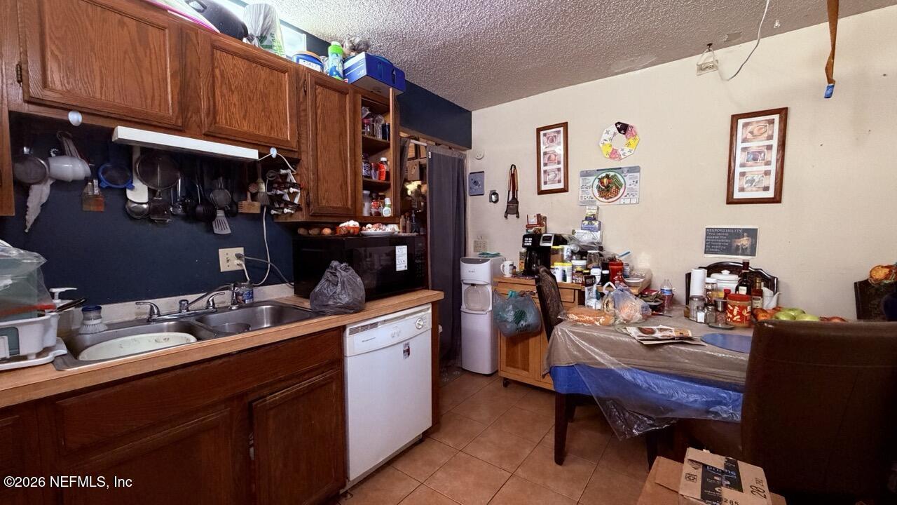 11432 Godfrey Way Jacksonville, FL 32223 - Photo 5 of 18 a room with a table chairs and a kitchen