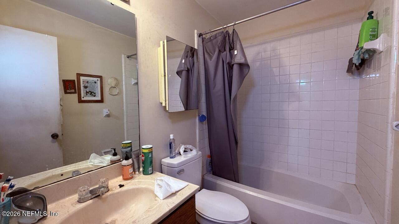 11432 Godfrey Way Jacksonville, FL 32223 - Photo 9 of 18 a bathroom with a sink toilet and shower