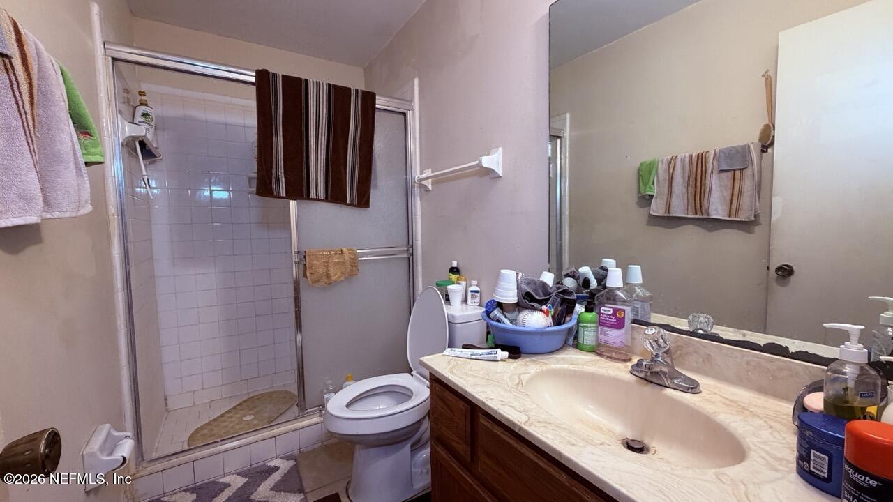 11432 Godfrey Way Jacksonville, FL 32223 - Photo 10 of 18 a bathroom with a sink toilet and shower