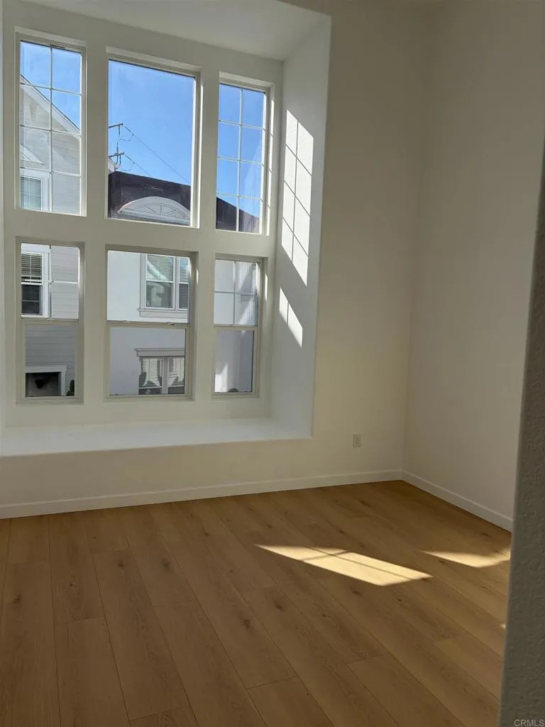 815 Harbor Cliff Way, Unit 239 Oceanside, NY 11572 - Photo 4 of 11 a view of a kitchen with wooden floor and cabinets