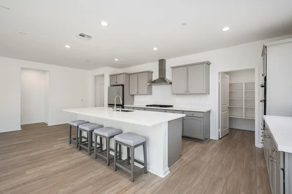 a view of a kitchen sink a window and wooden floor