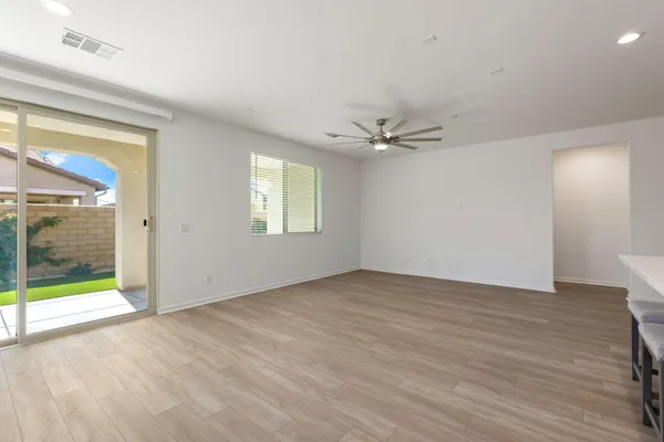a view of a livingroom with a flat screen tv wooden floor and staircase