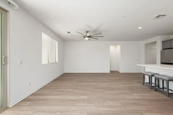 a view of kitchen with kitchen island microwave and wooden floor
