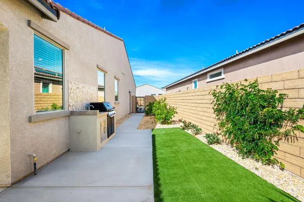 a view of an house with backyard space and palm tree