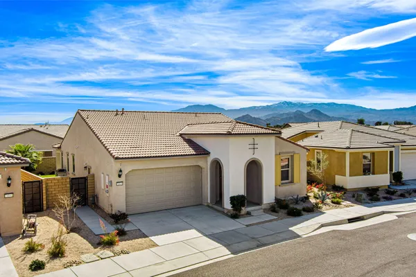 a view of house with a backyard
