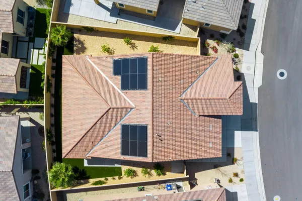 an aerial view of a house with a yard