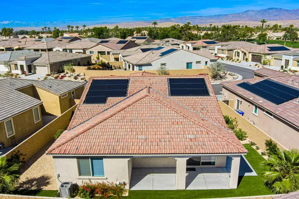 an aerial view of a house with a yard and lake view