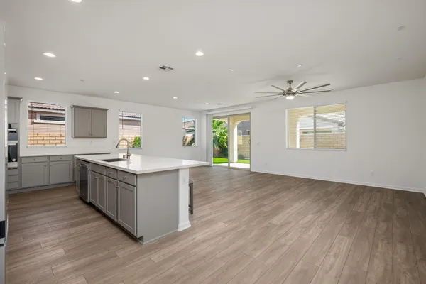 a large kitchen with stainless steel appliances a refrigerator and a counter top space
