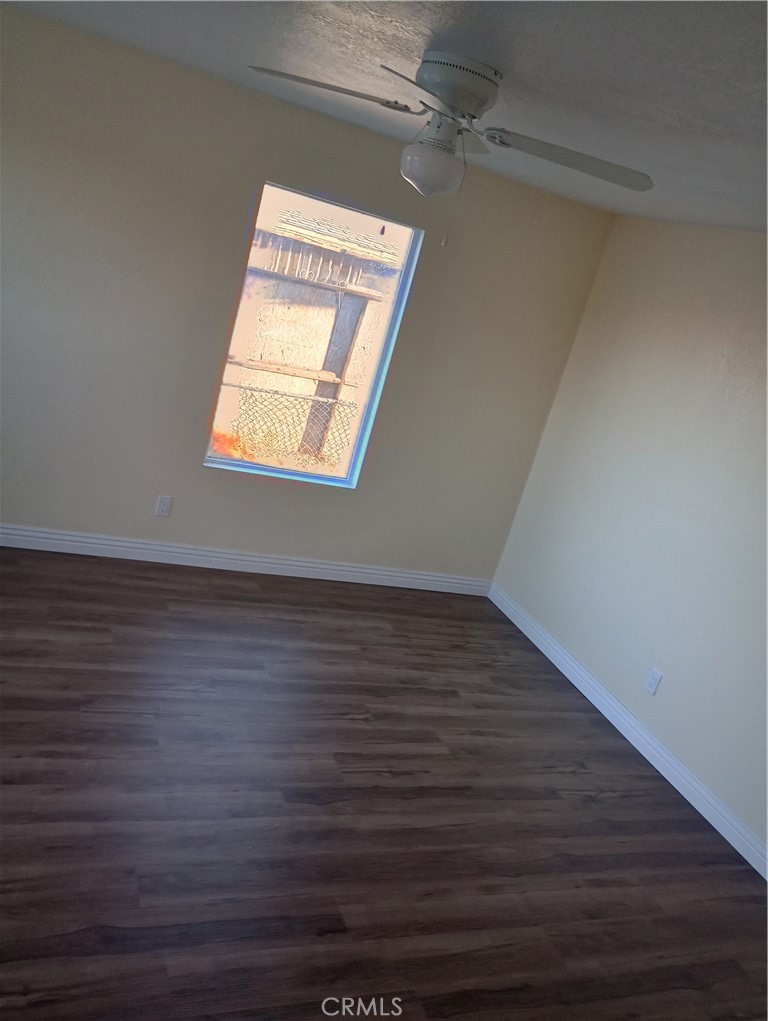 1426 Riverside Drive Barstow, CA 92311 - Photo 11 of 19 a view of an empty room with wooden floor and a window
