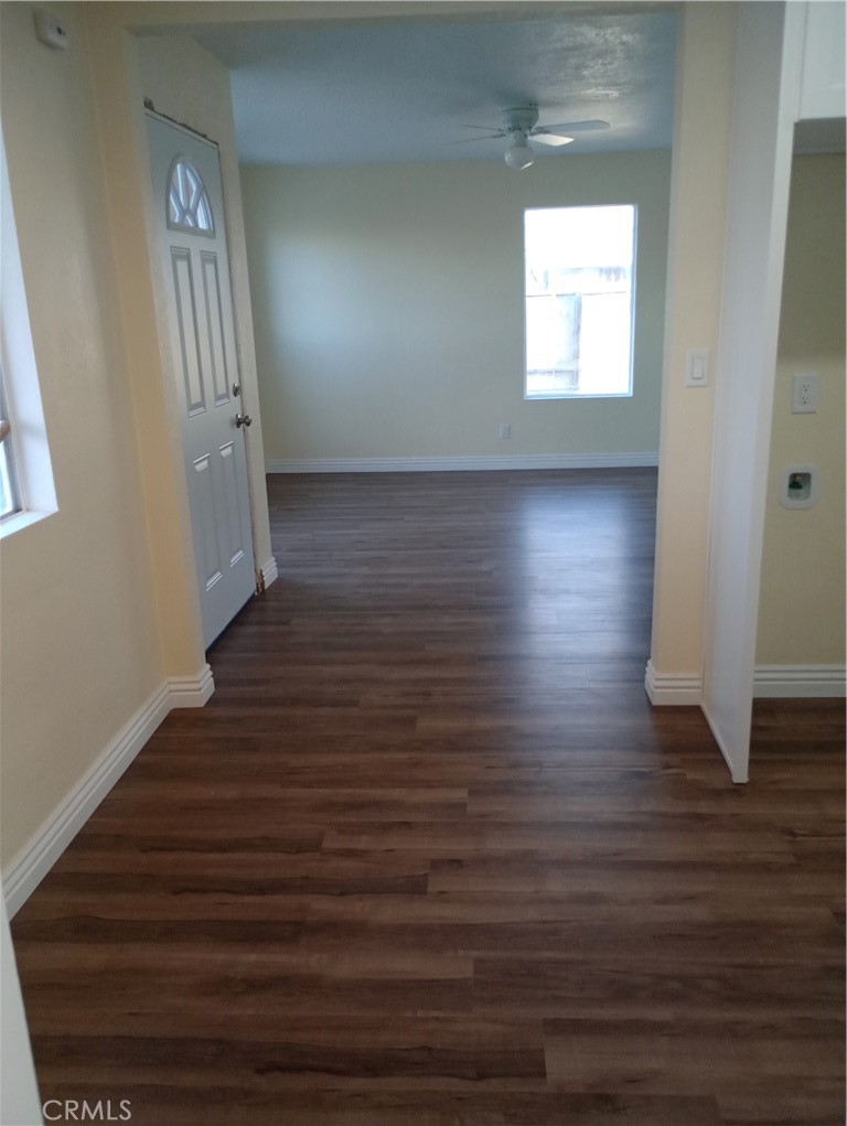 1426 Riverside Drive Barstow, CA 92311 - Photo 4 of 19 a view of an empty room with wooden floor and a window
