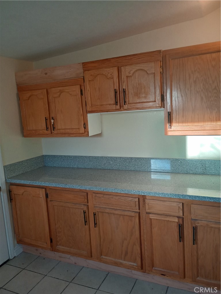 1426 Riverside Drive Barstow, CA 92311 - Photo 7 of 19 a kitchen with cabinets and white countertops