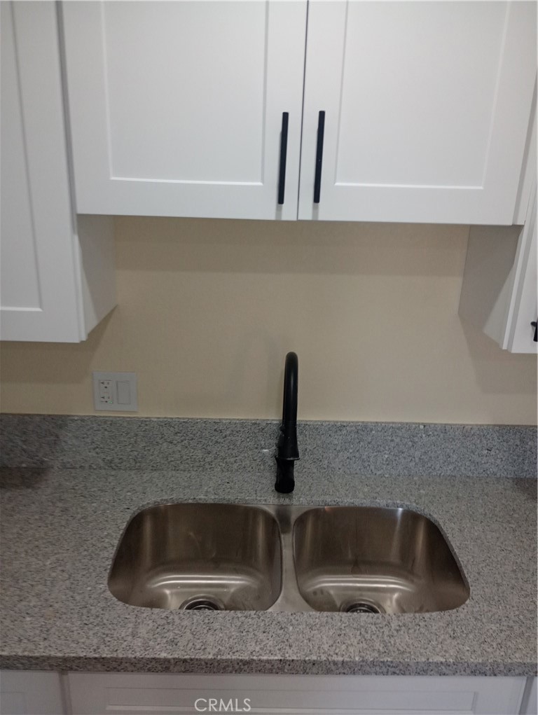 1426 Riverside Drive Barstow, CA 92311 - Photo 8 of 19 a kitchen with a sink and refrigerator