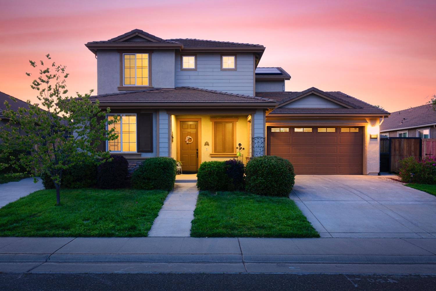 a front view of a house with garden