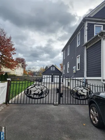 a couple of cars parked in front of a house
